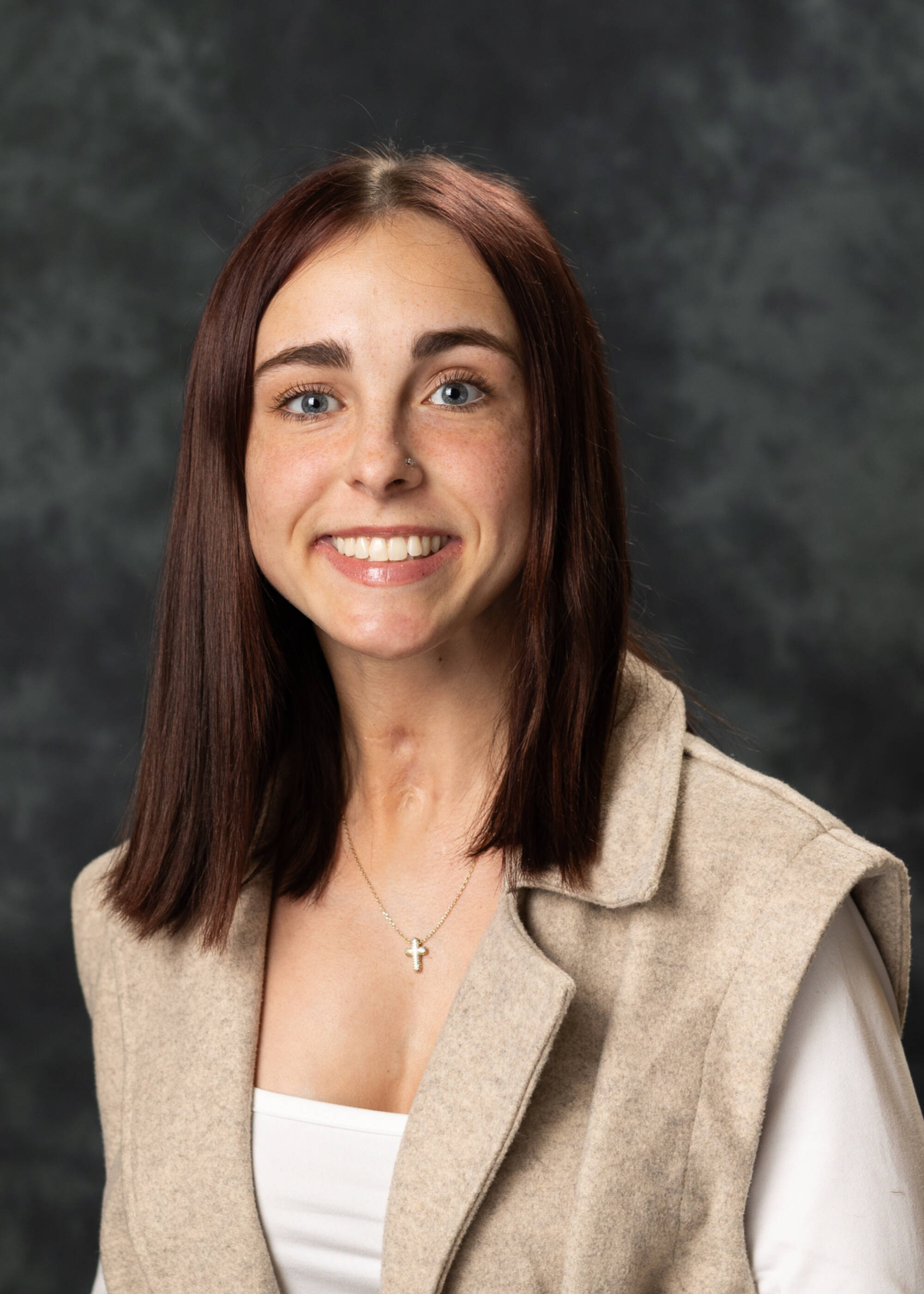 Emma Leonard smiling in a tan top